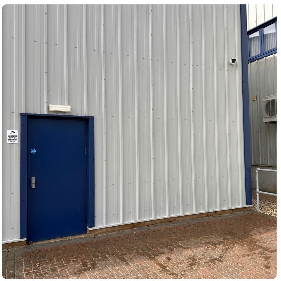 Same entrance after Eastrada exterior clean — cladding panels uniformly white
