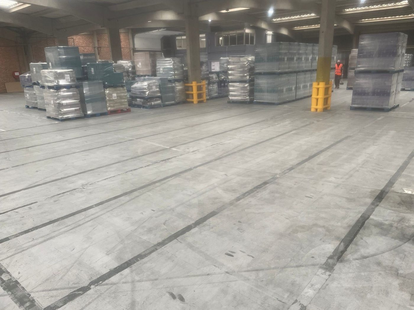 Warehouse floor with worn blue tape markings prior to industrial line marking