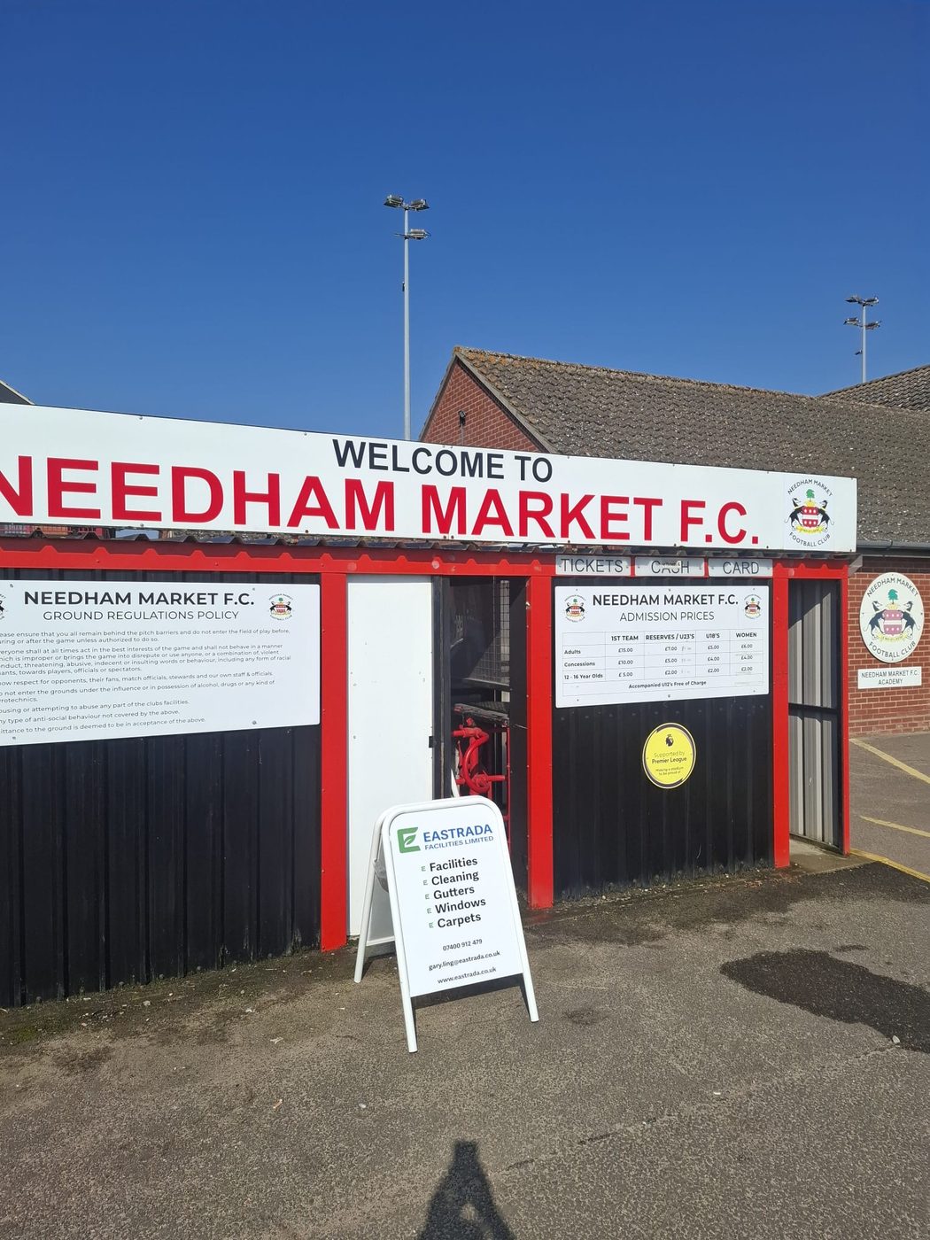 Eastrada Facilities branded A-frame sign at the entrance to Needham Market FC ahead of a full facilities clean